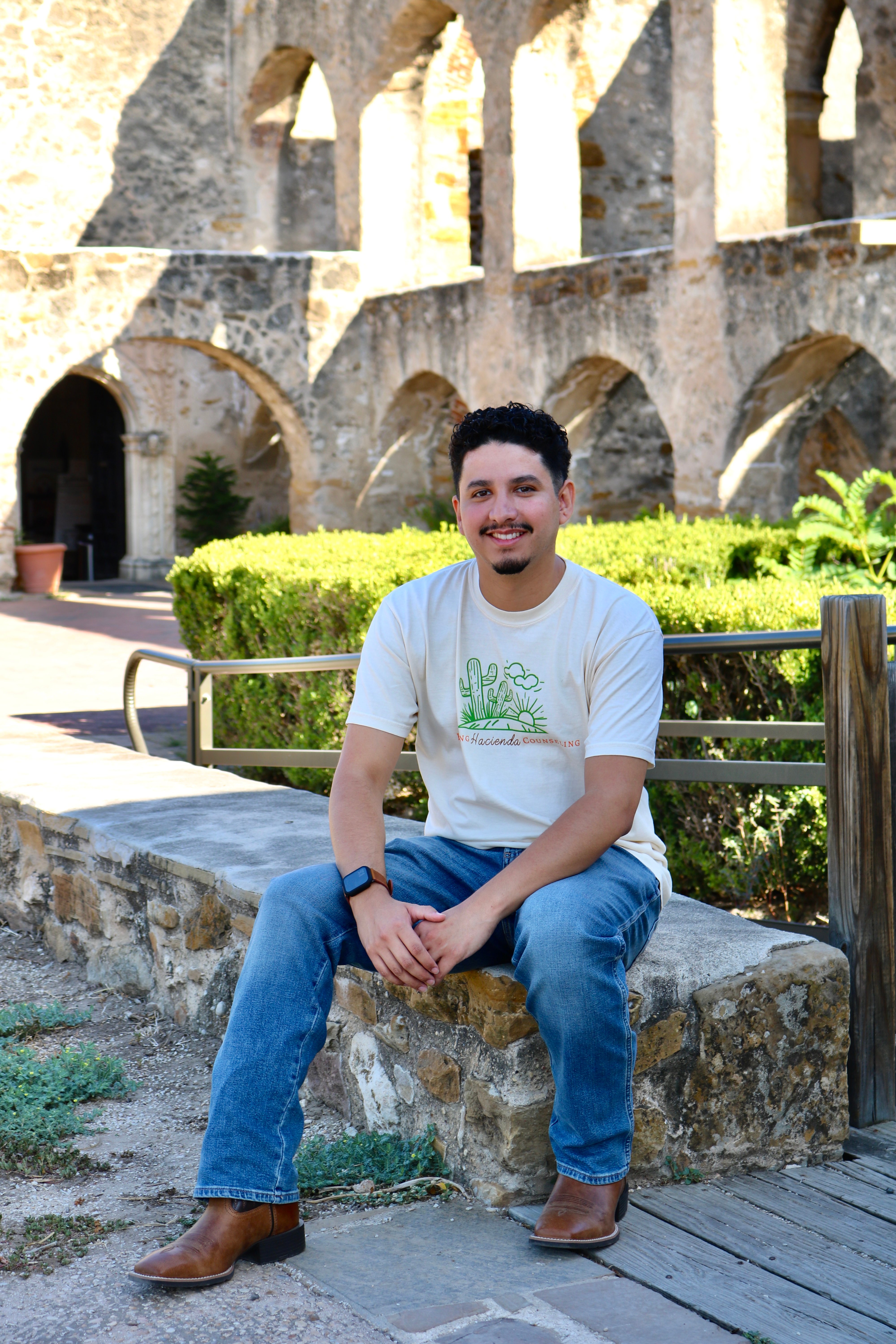 Jorge Humberto Ortiz seated in the courtyard at Mission San José