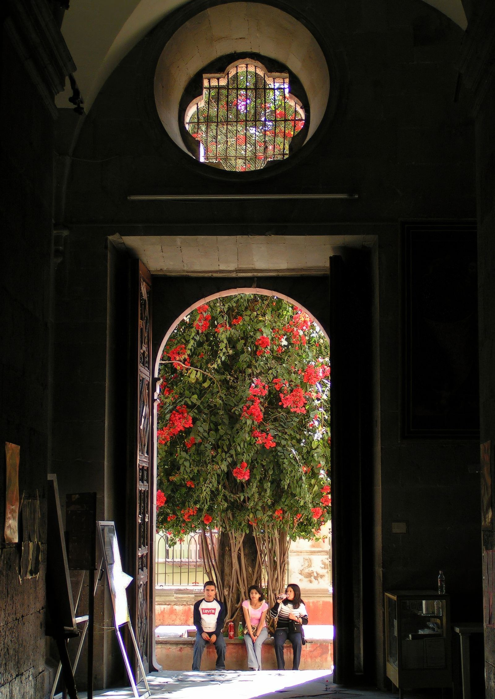 A quiet historic archway in Guanajuato opening onto a flowering bougainvillea